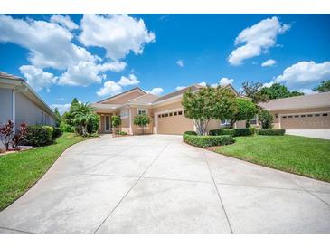 Charming single-story home featuring a well manicured lawn and a spacious driveway at 2425 Laurel Glen Dr, Lakeland, FL 33803