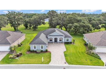 Stunning single-story home boasts lush landscaping and a brick-paved driveway in a serene neighborhood at 3176 Pearly Dr, Lakeland, FL 33812