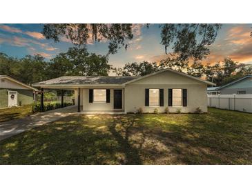 Charming single-story home featuring a well-maintained lawn, neutral paint, and a covered carport at 3829 Abbott Ln, Lakeland, FL 33810