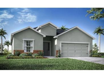 Charming one-story home featuring a symmetrical facade, complemented by a manicured lawn and lush landscaping at 1444 Fleur Dr, Davenport, FL 33837