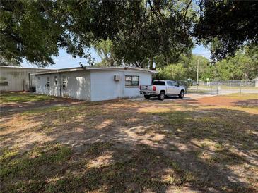 View of the building exterior, mature landscaping, with truck parked on the side at 3651 Rifle Range Rd, Winter Haven, FL 33880