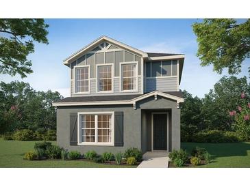 Charming two-story home featuring vertical siding, large windows and a welcoming front porch at 485 Silverbell Trl, St Cloud, FL 34771
