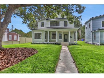 Charming two-story home with a welcoming front porch and meticulously manicured lawn at 731 S Missouri Ave, Lakeland, FL 33815