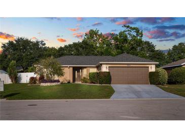 Charming single-story home featuring a well-manicured lawn, neutral paint, and a two-car garage at 8904 Pebblebrooke Dr, Lakeland, FL 33810
