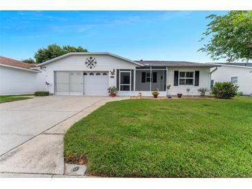 Charming single-story home featuring a well-maintained lawn, attached garage, and a cozy screened-in porch at 3487 Highland Fairways Blvd, Lakeland, FL 33810