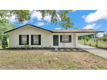 Charming home with a new landscape, fresh white paint and contrasting black trim and a carport at 408 Sycamore Sw St, Fort Meade, FL 33841