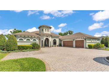 Stunning single-story home boasts a circular driveway and attached two-car garage at 6475 Avalon Woods Dr, Lakeland, FL 33813