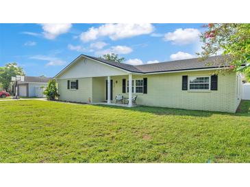 Charming single-story home with a well-manicured lawn, inviting front porch and side-entry garage at 934 Point View Ln, Lakeland, FL 33813