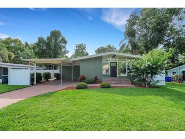 Charming single-story home featuring a well-manicured lawn and covered carport at 941 Avon Ave, Lakeland, FL 33801