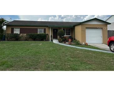 Cozy one-story home with a well-maintained lawn and an attached single-car garage at 322 Ne 9Th St, Mulberry, FL 33860