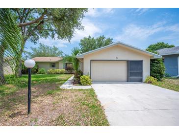 Charming single-story home with a two-car garage, lush landscaping, and inviting curb appeal at 5 Pine Run, Haines City, FL 33844
