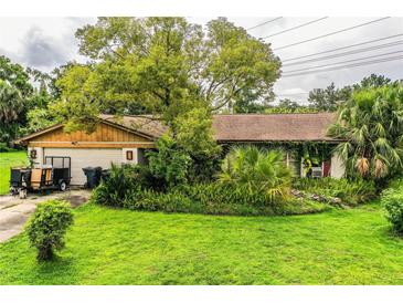 Charming single-story home with mature trees and lush landscaping in a desirable neighborhood at 6134 Christina E Dr, Lakeland, FL 33813