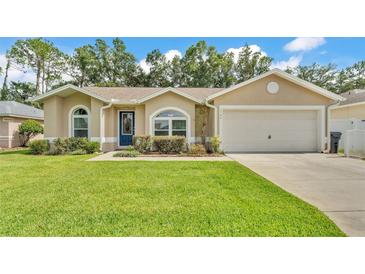 Inviting single-story home featuring a well-manicured lawn and a classic, neutral-toned exterior at 1746 Grey Fox Dr, Lakeland, FL 33810