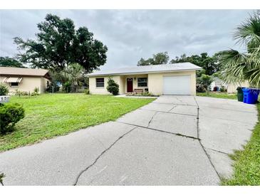 Charming single-story home with a well-maintained lawn and a convenient attached garage at 355 Pico Ct, Lakeland, FL 33809