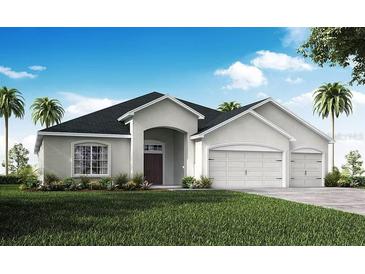 Charming single-story home featuring a well-manicured lawn, an arched entryway, and an attached two-car garage at 563 Silver Course Radl, Ocala, FL 34472