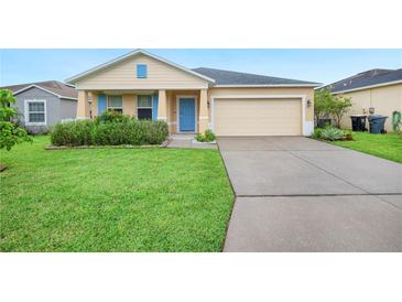 Charming single-story home featuring a well-manicured lawn, blue shutters, and an attached two-car garage at 6819 Glenbrook Dr, Lakeland, FL 33811