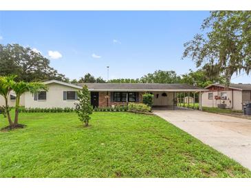 Charming single-story home featuring a well-manicured lawn and covered carport at 848 17Th Ne Ter, Winter Haven, FL 33881