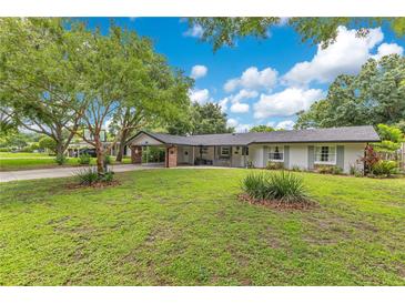 Charming single-story home with a well-maintained lawn and inviting carport entrance at 1715 Lando Ln, Orlando, FL 32806