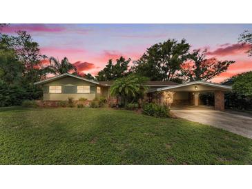 Charming single-story home featuring a well-maintained lawn, carport, and inviting curb appeal at 4219 Forest Hills Dr, Lakeland, FL 33813