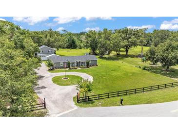 Sprawling property featuring a single story home, a second residence, and a circular driveway at 59 Jimmy Lee Rd, Winter Haven, FL 33880