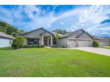Beautiful front yard with lush green grass and a well-maintained exterior, featuring a three-car garage at 967 Hunters Meadow Ln, Lakeland, FL 33809