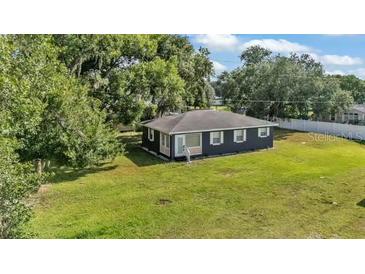 Charming single-story home with a well-maintained yard and mature trees providing ample shade at 1050 Reynolds Rd, Lakeland, FL 33801