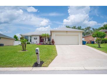 Charming single-story home featuring a well-manicured lawn and attached two-car garage at 1420 Meadows Pond Dr, Bartow, FL 33830