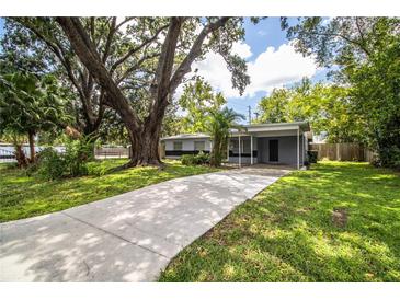 Charming single-story home with a long driveway and lush green lawn at 1604 Park Dr, Lakeland, FL 33803