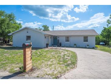 Charming single-story home with a well-maintained lawn and a curved driveway leading to the front entrance at 1948 Oakland Park Dr, Lake Wales, FL 33898