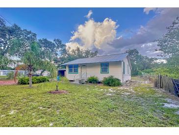 Charming home featuring freshly cut green grass and a well-maintained landscape at 200 Spurlock Rd, Frostproof, FL 33843