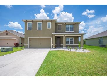 Charming two-story home with a well-manicured lawn and two car garage at 2062 Blue Highlands Dr, Lakeland, FL 33811