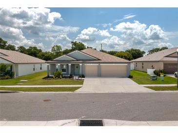 Charming single-story home with a well-manicured lawn and a two-car garage at 2958 Flying Blackbird Rd, Bartow, FL 33830