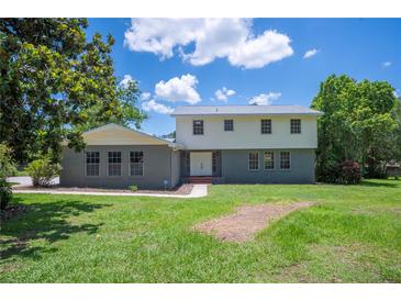 Charming home featuring a mix of brick and vinyl siding, complemented by a well-maintained lawn and mature trees at 4908 S Bedford Ln, Lakeland, FL 33813