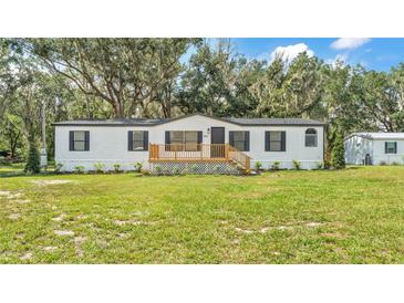 Charming single-story home with a inviting front porch and well-manicured lawn at 4931 Dove Cross Dr, Lakeland, FL 33810