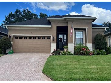 Well-maintained single Gathering home with a brick driveway, tidy landscaping, and a two car garage at 961 Christina Chase Dr, Lakeland, FL 33813