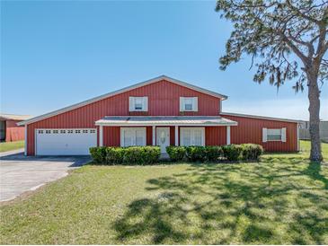 Charming two-story home with landscaped yard and attached two-car garage at 4230 Viola Rd, Lakeland, FL 33810