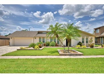 Charming single-story home featuring lush landscaping, a well-manicured lawn, and beautiful curb appeal at 5313 Nichols W Dr, Lakeland, FL 33812