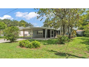 Charming single-story home with a covered carport and screened porch, surrounded by lush landscaping at 640 Forrest Dr, Bartow, FL 33830