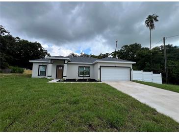 Charming single-story home with a well-manicured lawn and two-car garage at 801 Robson W St, Lakeland, FL 33805