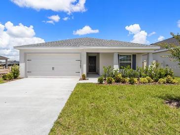 Charming single-story home with a well-maintained lawn and a two-car garage at 3167 Laurel Oak Ln, Winter Haven, FL 33884