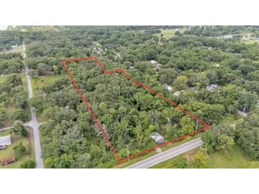 Aerial view showcasing the boundaries of a heavily wooded lot with mature trees and road access at 4035 K Ville Ave, Auburndale, FL 33823