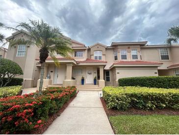 Inviting two-story townhome featuring well-maintained landscaping and a red tile roof at 443 Enclave Pl # 0, Lakeland, FL 33803