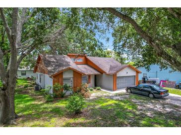 Attractive home showcasing the garage, shutters, landscaping, and front door at 4720 Wildflower Dr Dr, Lakeland, FL 33811