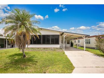 Charming single Gathering home featuring a convenient carport and well maintained lawn at 6443 Hollyberry Ne Ln, Winter Haven, FL 33881