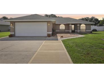 Charming single-story home featuring a two-car garage and well-maintained front yard at 8219 Rangers Path, Lakeland, FL 33809