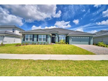 Charming single-story home with lush front lawn and beautifully landscaped front yard at 5298 Tennessee Ridge Ct, Auburndale, FL 33823