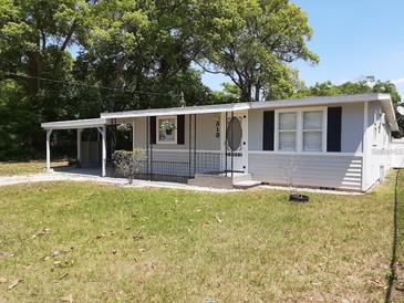 Gray house with carport and fenced yard at 313 S Ridgewood Ave, Deland, FL 32720