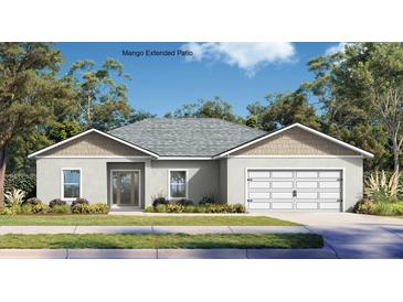 Charming single-story home featuring a two-car garage, neutral stucco, and a well-manicured front lawn at 402 Oliver Dr, New Smyrna Beach, FL 32168