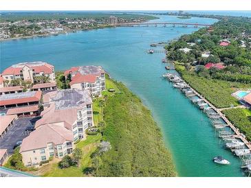 Aerial view of waterfront condo building near bridge and waterway at 434 Bouchelle Dr # 304, New Smyrna Beach, FL 32169