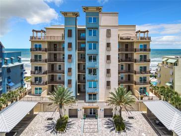 Oceanfront luxury condo building with balconies and parking at 807 S Atlantic Ave # 302, New Smyrna Beach, FL 32169